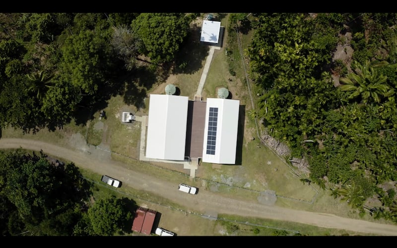 A simplified meetinghouse in Papua New Guinea equipped with solar panels and satellite internet enables congregations to gather, study and participate in Church programs in remote areas.