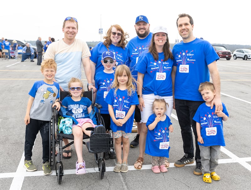 Families and friends wearing blue America 250 JustServe t-shirts attend a Kansas City Royals game in Kansas City, Missouri, Thursday, April 9, 2026.