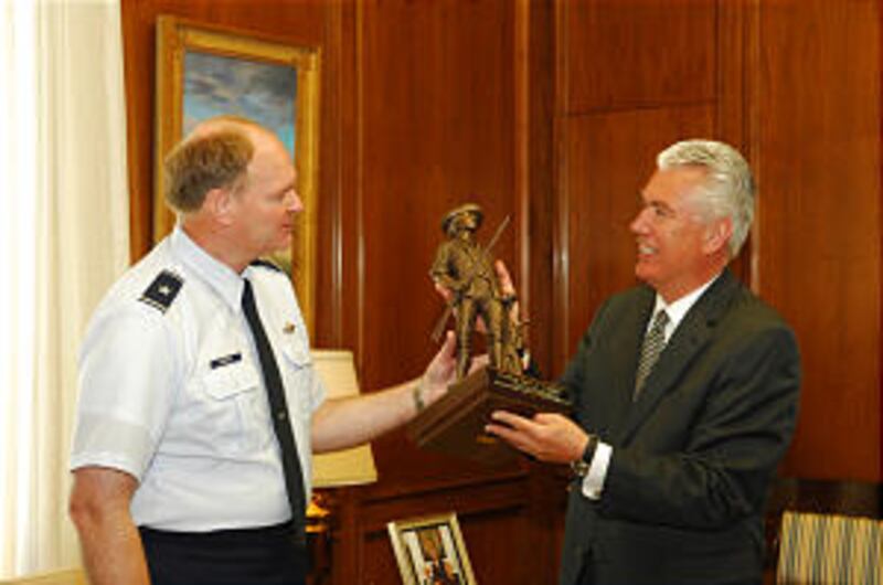 Brig. Gen. David Hooper presents President Dieter F. Uchtdorf with a bronze statue of the "Concord M