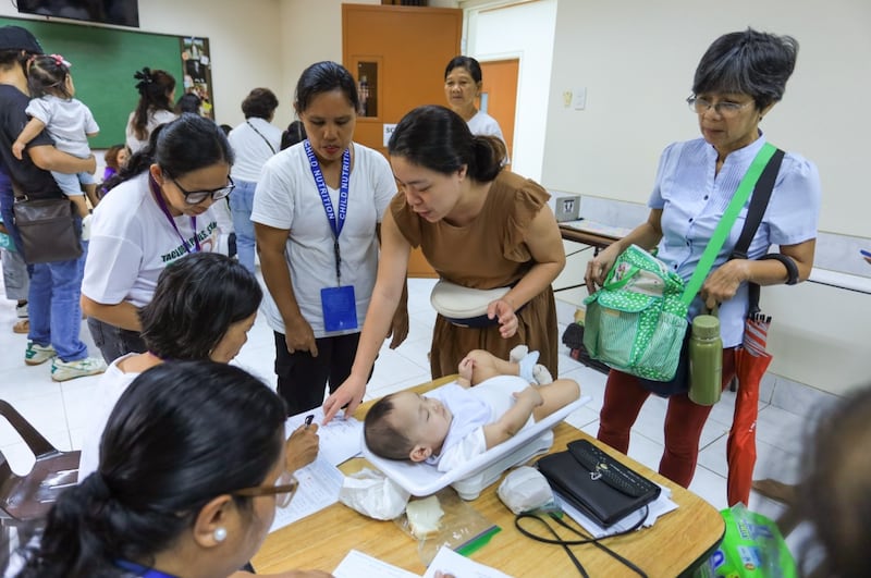 A child is weighed during a health and nutrition screening in Tacloban City, Philippines, Sept. 19, 2026.