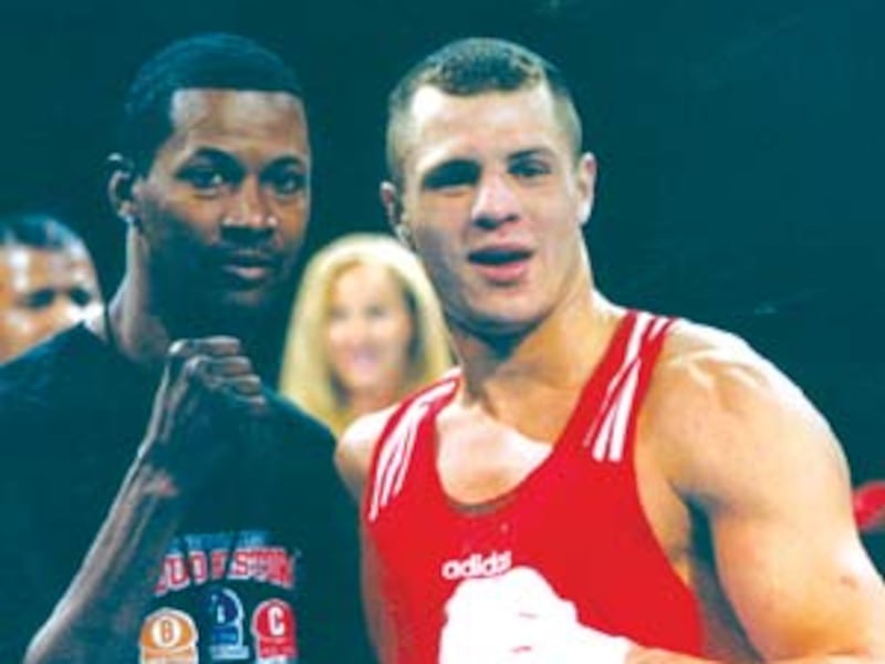 Two-time national champion B.J. Flores, right, enjoys his title with former Olympic and professional