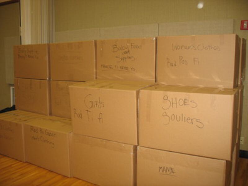 Boxes labeled in English and Creole ready to be loaded in shipping container.