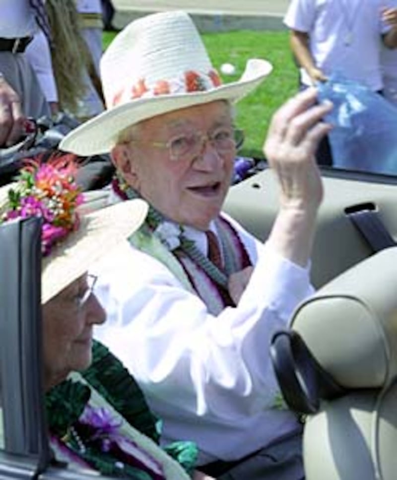 President Hinckley, with wife, Marjorie, waves at crowd during Laie community parade. Hundreds lined