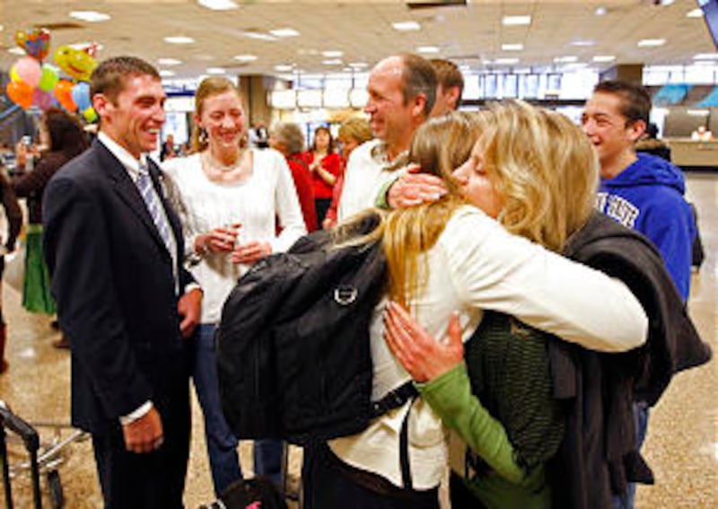 Cindy Hawkins hugs her daughter Breanne as Kevin and Breanne Hawkins return home from their mission