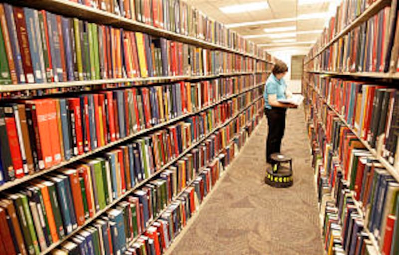 Elissa Powell, Pittsgurgh, Pa., looks over published family histories at the Family History Library.