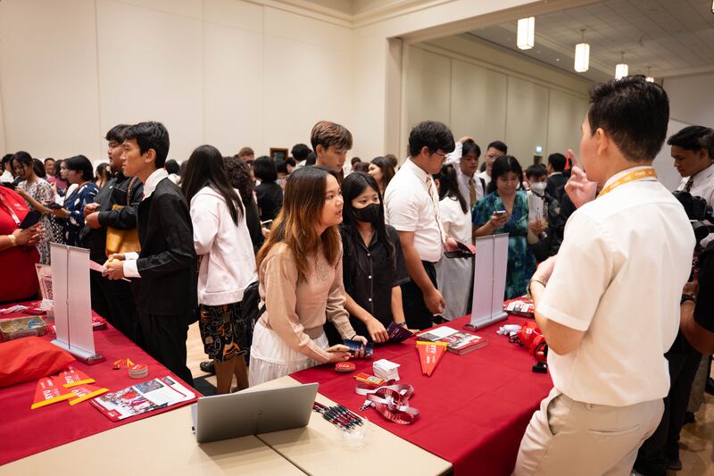 Participants visit the BYU–Hawaii booth at the Asia Area education fair in Bangkok, Thailand, Oct. 19, 2025.
