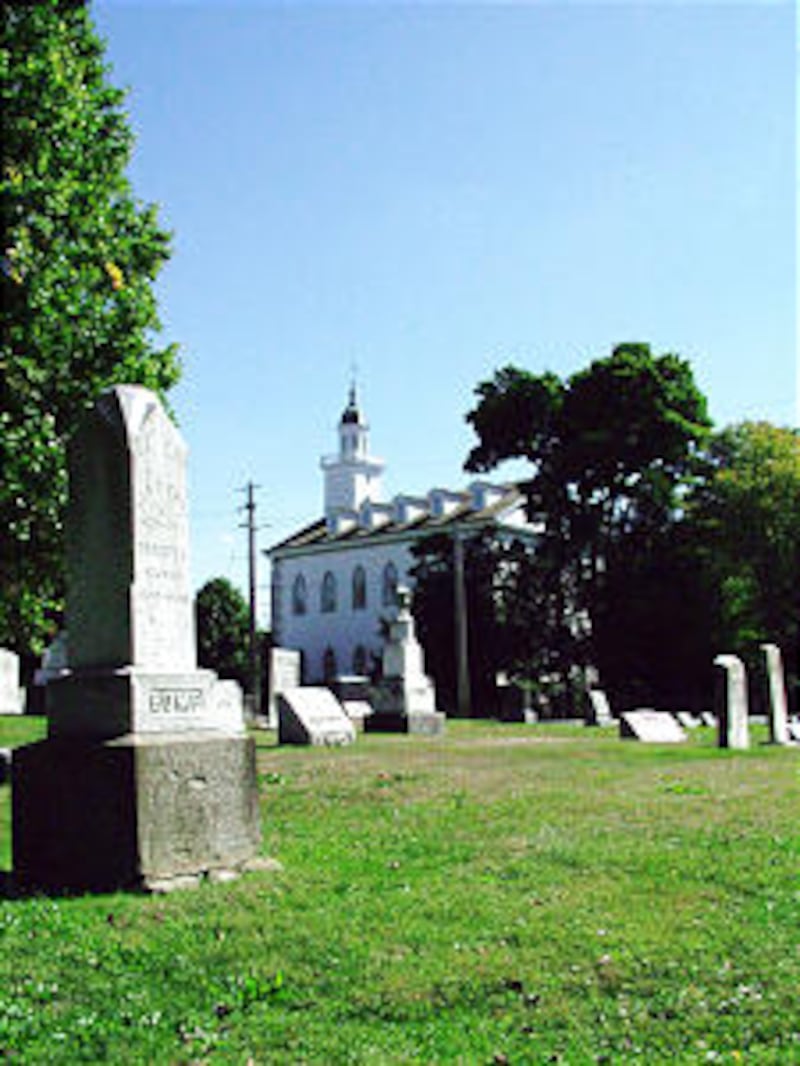 Kirtland Temple, now owned by the Community of Christ, stands as backdrop to pioneer cemetery and is