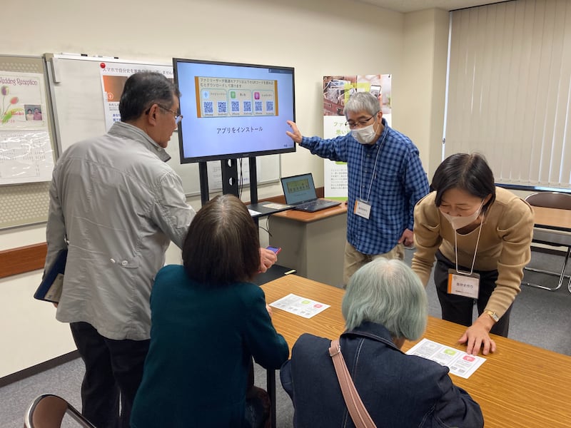 Individuals learn how to use FamilySearch apps on their smartphones during a family history fair in Kagoshima, Japan, Feb. 23, 2026.