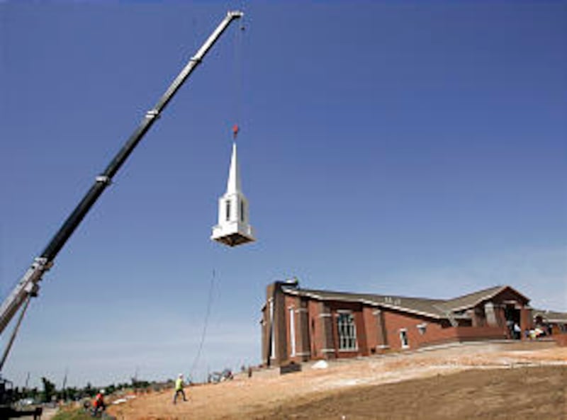 At the one-year anniversary remembrance of the tornado in Joplin, Mo., a new steeple was placed on t