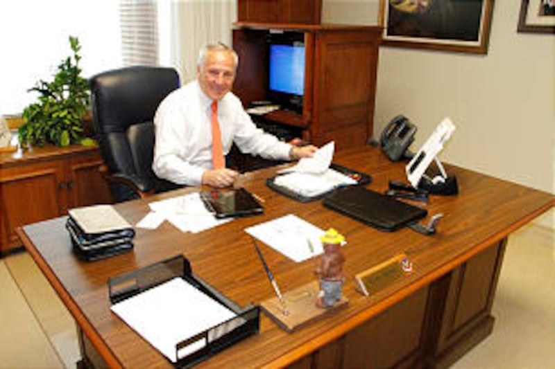 Elder Bruce A. Carlson of the Seventy sits at his desk in the Church Administration Building. After