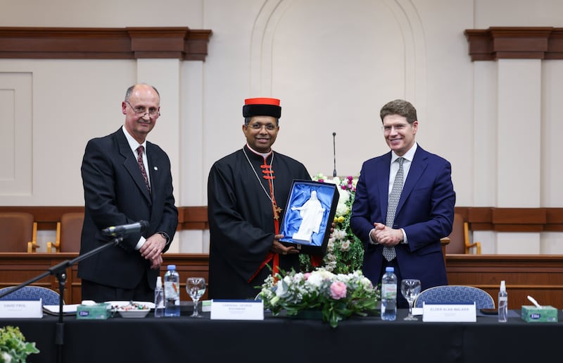 Cardinal George Jacob Koovakad, prefect of the Dicastery for Interreligious Dialogue, middle, holds a miniature Christus statue with Elder Alan R. Walker, a General Authority Seventy and president of the Church's South America South Area, standing to the right at an interfaith event in Buenos Aires, Argentina, on Sept. 10, 2026.