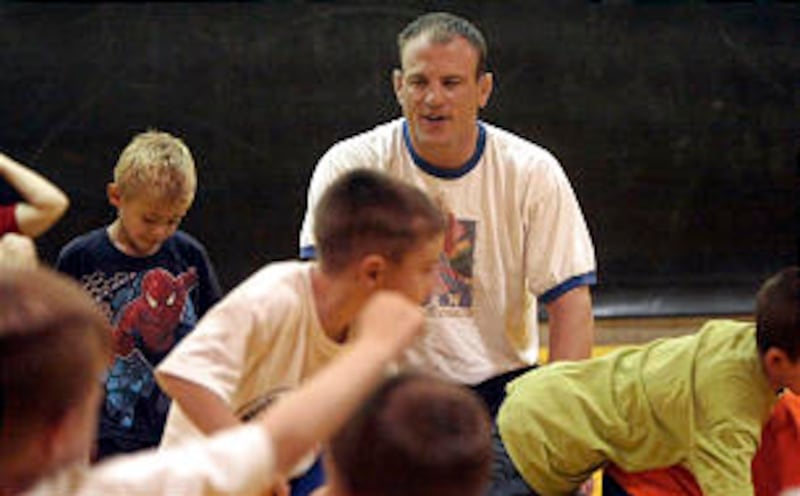 Cael Sanderson works with young participants at his wrestling camp at Wasatch High School in Heber i