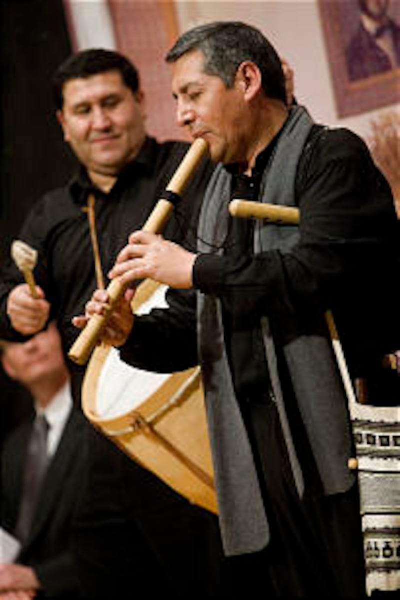 Edgar Zurita plays the flute with his Andean band at the opening of "A Book of Mormon Fiesta" exhibi