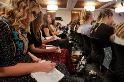 Missionaries take notes during a devotional at the Provo Missionary Training Center in Provo, Utah, on Tuesday, May 10, 2022.