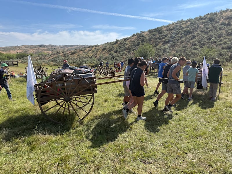 Spokane Valley Washington Stake youth pull a wheelbarrow up Dryback Mountain in Bend, Idaho, on June 25, 2026, during a stake youth trekking activity.