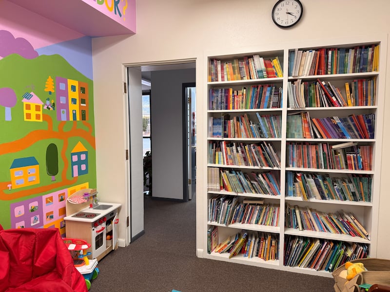 A bookshelf in the American Fork United Way Community Center is filled with donated books from the Orem Utah Sunset Heights 3rd Ward Primary book drive in September 2025.