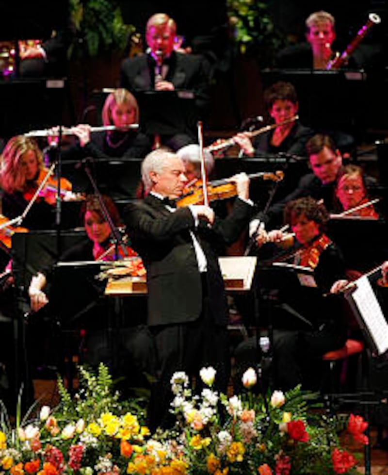 Conductor Igor Gruppman of the Orchestra at Temple Square Spring concert plays a violin solo.