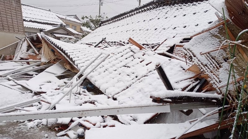 Snow falls on a damaged building after the Noto Peninsula earthquake in Japan.