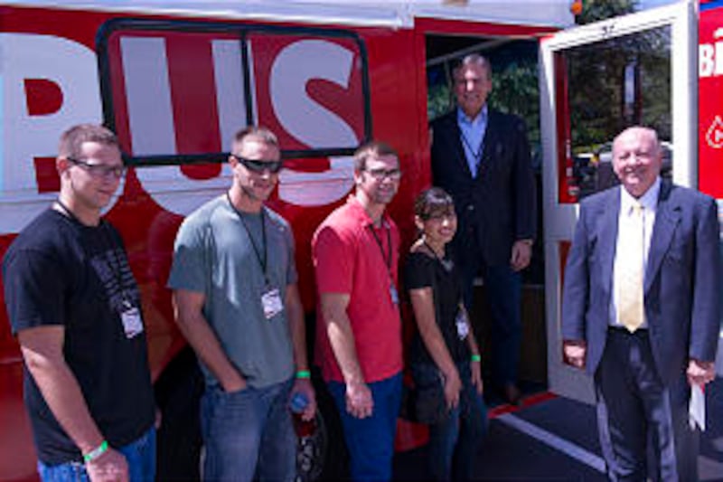 Rick Walsh, chairman of One Blood, and Elder Rulon Munns welcome young single adults to "The Big Red