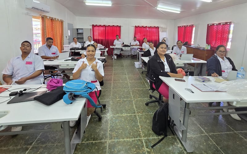 The 14 students of the inaugural class of the Bachelor of Oral Health program smile in the dental classroom at Vaiola Hospital in Nukuʻalofa, Tonga, in March 2026.