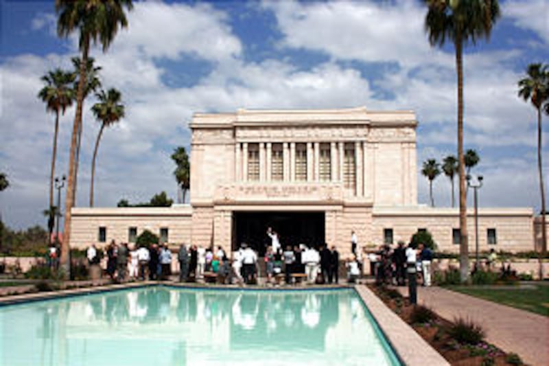 Family surrounds a newlywed couple outside the Mesa Arizona Temple. After decades of growth in Arizo
