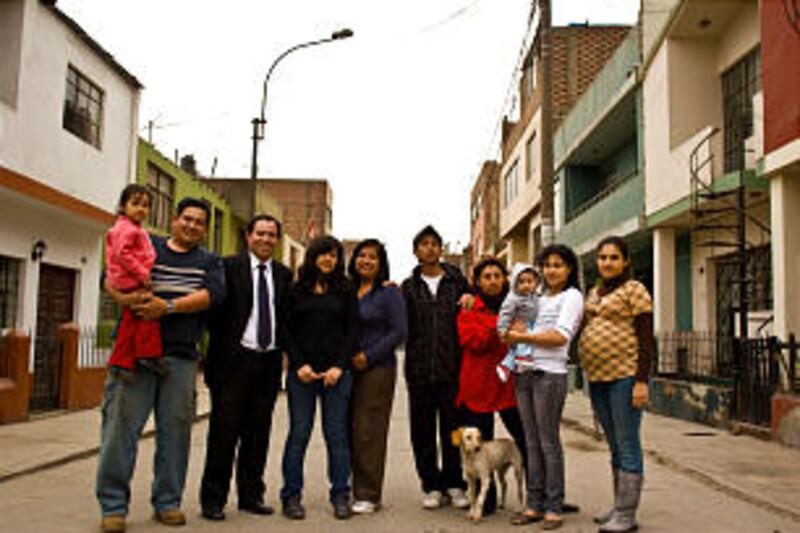 Bishop Carlos Salinas Villantoy, of the Jose Galvez Ward, Lima Peru Independencia stake, standing wi