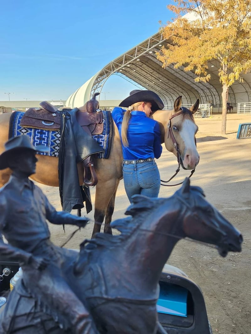 Brogan Hill hugs her horse, Quik Draw McGraw, the Great Western Reining Horse Association Low Roller Reining Classic in Nampa, Idaho, in October 2022.