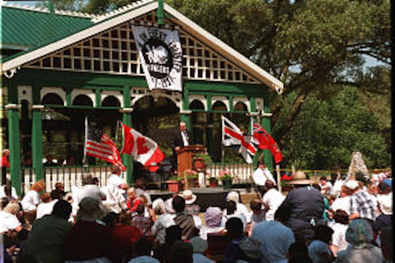 President Monson speaks at 1997 outdoor meeting in Ontario, during which he dedicated marker honorin