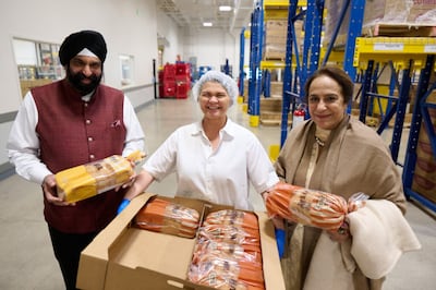 Sikh leaders from Dubai, Surender Kandhari and Bubbles Kandhari, meet with a bread baker at Welfare Square on April 29, 2022.