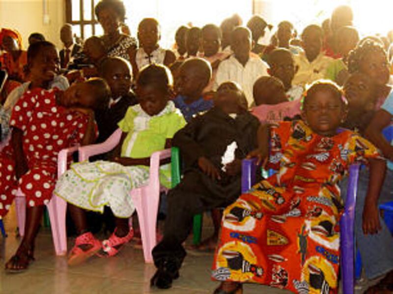 Children overcome by heat and fatigue wait for special meeting to begin in the Bangui Branch in the