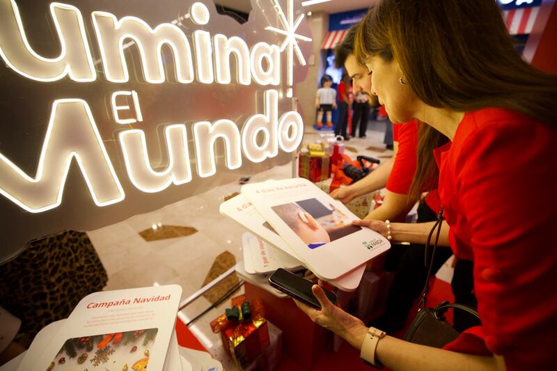 Volunteers at the Giving Machines in Buenos Aires, Argentina, sift through cards people can select to donate items and services, on the day of the machines' unveiling in Argentina on Nov. 30, 2025.