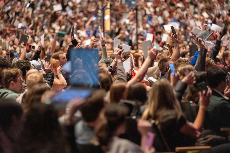 BYU–Idaho students raise their notebooks and note-taking devices to show their readiness to be taught by Elder Aaron T. Hall, General Authority Seventy, in a devotional address in Rexburg, Idaho, on Tuesday, March 3, 2026.