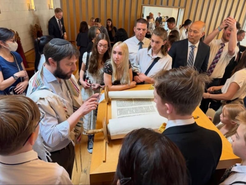 Rabbi Andrew Scheer shares information about the Torah with youth and adult members of the Church's Tokyo Japan South Stake (English) during a visit to the Jewish Community of Japan Synagogue on May 17, 2026 in Tokyo.