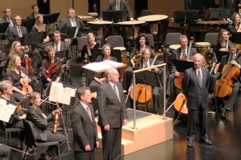 Ryan Murphy, Mack Wilberg and guest conductor, Ron Rockow, stand before the Mormon Tabernacle Choir