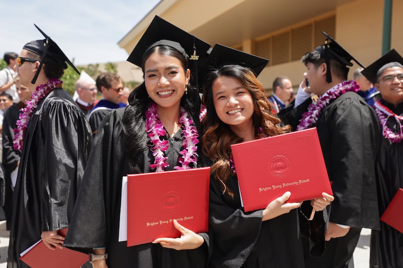 BYU–Hawaii graduates take photos outside the Cannon Activities Center following commencement on Friday, April 17, 2026, in Laie, Hawaii.