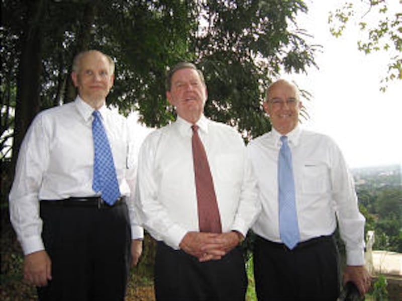 Elder Dale G. Renlund, Elder Jeffrey R. Holland and Elder L. Whitney Clayton pause for a moment at t