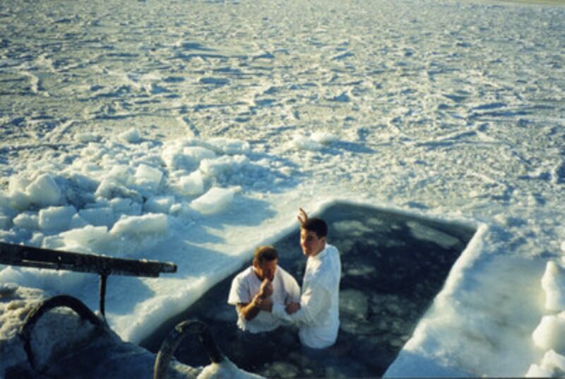 Elder Aaron C. Varney baptizes Sergei Kazarinov in a hole cut in the ice near Vladivostok, Russia, i