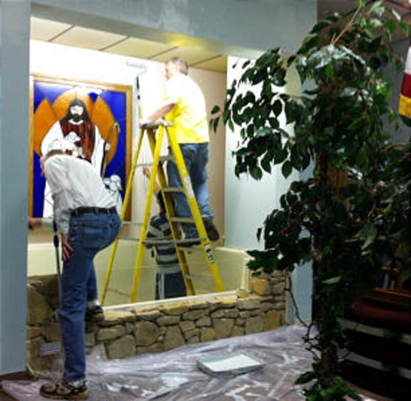 Joplin Stake President and LDS missionaries paint around the Community of Christ baptismal font.
