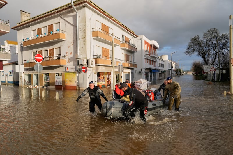 Residents are evacuated by inflatable raft after heavy rains and flooding in Alcácer do Sal, Portugal, Feb. 6, 2026.