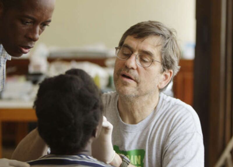 Dr. Mark Rampton cares for an Earthquake victim at a clinic set up in an LDS Centrale Ward Church