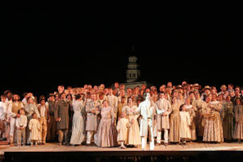 Dallin Bayles, portraying the Prophet Joseph Smith, stands in foreground before the cast of the new
