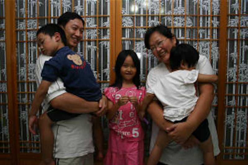 Eric and Kate Weng, with children, from left, Matthew, Iris and Faith.