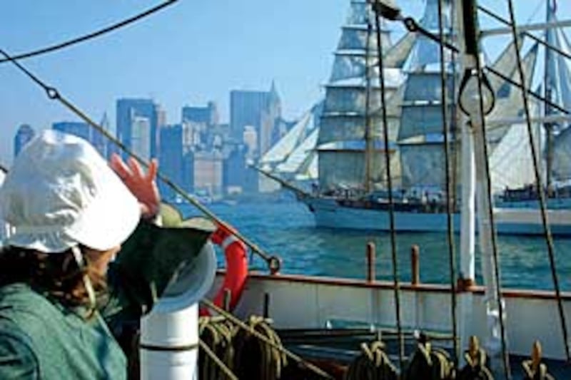 The Manhattan skyline and a sister ship provide contrast of modern and historic times for those aboa