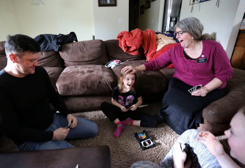 Jesse Kinman, his daughter Jade Wilkie, mother Diane Kienholz, and daughter Jordan Wilkie play Uno at Kienholz’s home in Puyallup, Wash., on Sunday, Jan. 26, 2020. Kinman is homeless but often spends Saturday night at his mother’s house with his daughters.