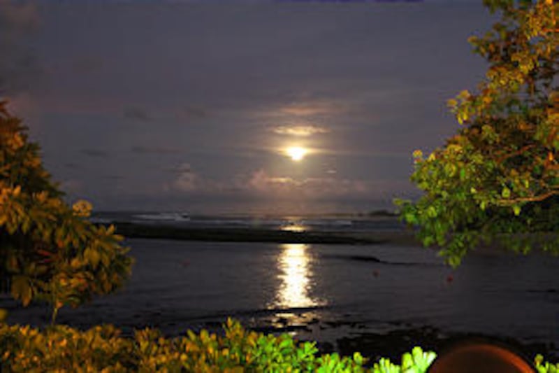 Sun sets on beach in Laie, Hawaii, on the North Shore of Oahu.