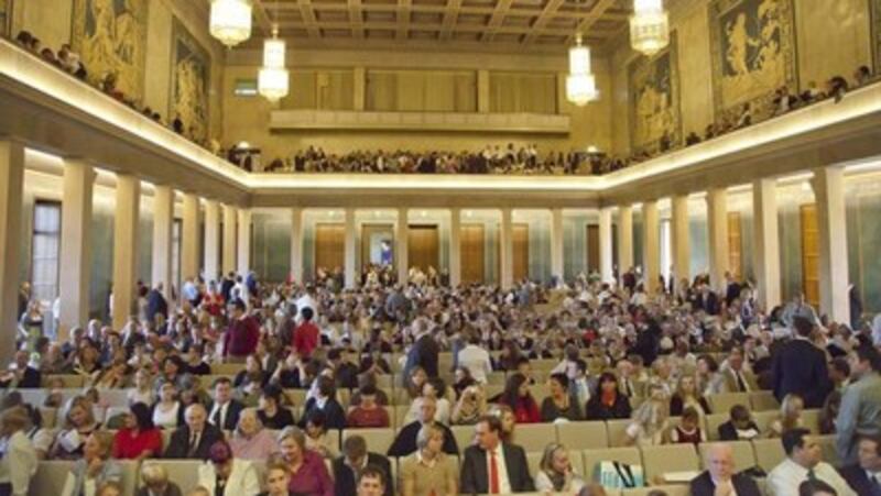 The visitors attending the meeting with President Thomas S. Monson in Munich, take their seats.