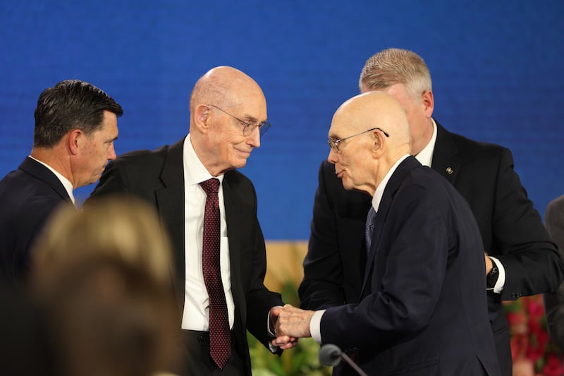 Church President Dallin H. Oaks, center right, shakes the hand of President Henry B. Eyring, first counselor in the First Presidency.