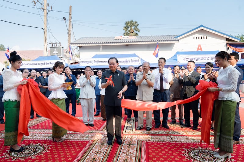 Onlookers clap Chheang Ra, health minister for the Kingdom of Cambodia, slices the ribbon to commemorate the opening of the new outpatient building at the Preah Net Preah Referral Hospital in the Banteay Meanchey province in northwestern Cambodia on Feb. 26, 2026.