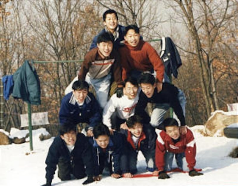 Among young men forming a pyramid in the snow are those labeled "loud boys" who went on to achieve s