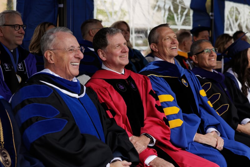 From left: Elder Ulisses Soares of the Quorum of the Twelve Apostles; Elder James R. Rasband, a General Authority Seventy; Keith Vorkink, BYU advancement vice president and Carlos Hernandez, BYU belonging vice president, watch the processional of graduates prior to commencement on Thursday, April 23, 2026, in Provo, Utah.
